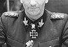 Herbert Otto Gille 1897-1966 SS-commandant Portret van SS-Gruppenführer Herbert Gille met onderscheidingen aan bureau, voorjaar 1944
